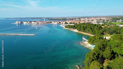 Aerial view of Poreč (Porec), Croatia, showcasing the charming old town, vibrant coastline, and the nearby island of Sveti Nikola. The stunning Zelena Laguna area adds to the beauty turquoise waters