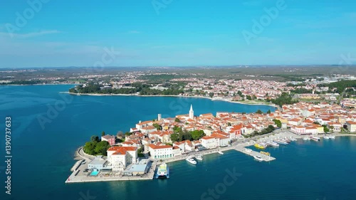 Aerial view of Poreč (Porec), Croatia, showcasing the charming old town, vibrant coastline, and the nearby island of Sveti Nikola. The stunning Zelena Laguna area adds to the beauty turquoise waters