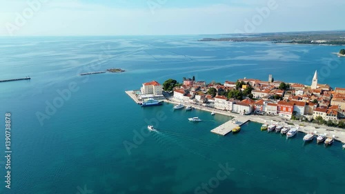 Aerial view of Poreč (Porec), Croatia, showcasing the charming old town, vibrant coastline, and the nearby island of Sveti Nikola. The stunning Zelena Laguna area adds to the beauty turquoise waters