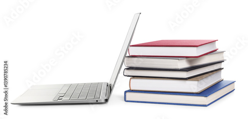 Closed hardcover books and laptop isolated on white