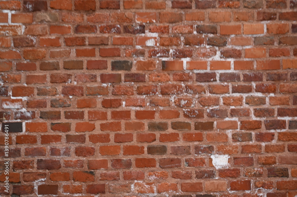 Obraz premium Old red brick wall texture with white efflorescence and weathered surface. Vintage masonry background for design, architecture, construction, and restoration projects. Rough textured red bricks with m