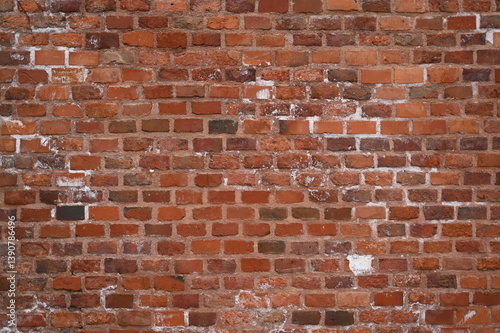 Old red brick wall texture with white efflorescence and weathered surface. Vintage masonry background for design, architecture, construction, and restoration projects. Rough textured red bricks with m