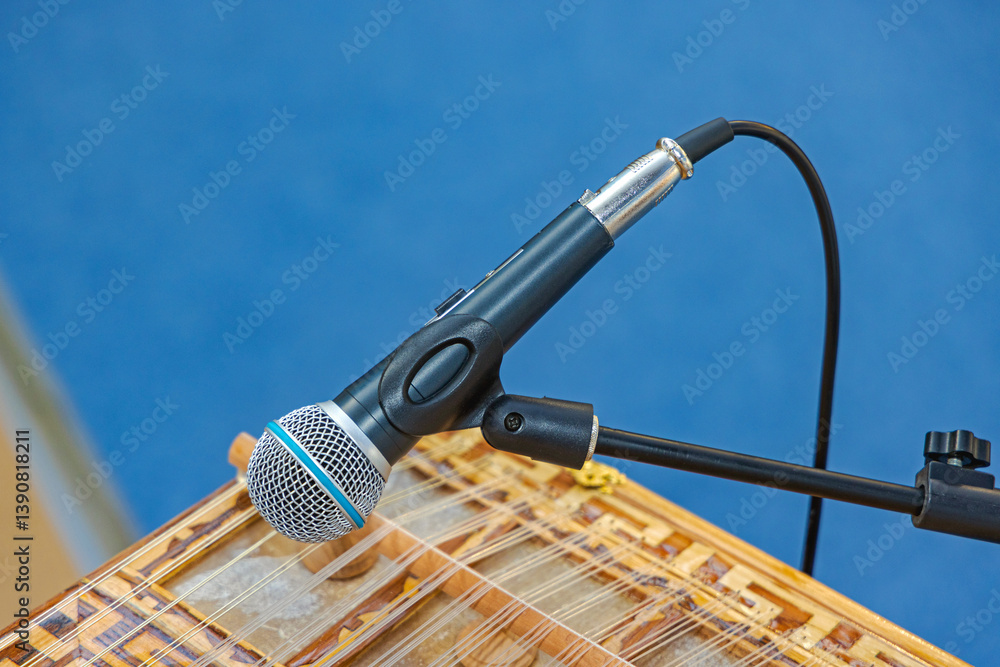 Classic Style Microphone With Wire at Tripod Holder Over Musical Instrument