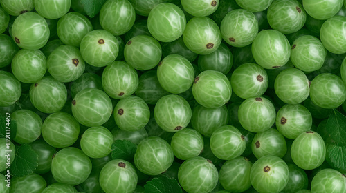 Fresh amla fruits arranged beautifully with green leaves on a flat surface, showcasing their rich texture and vibrant color