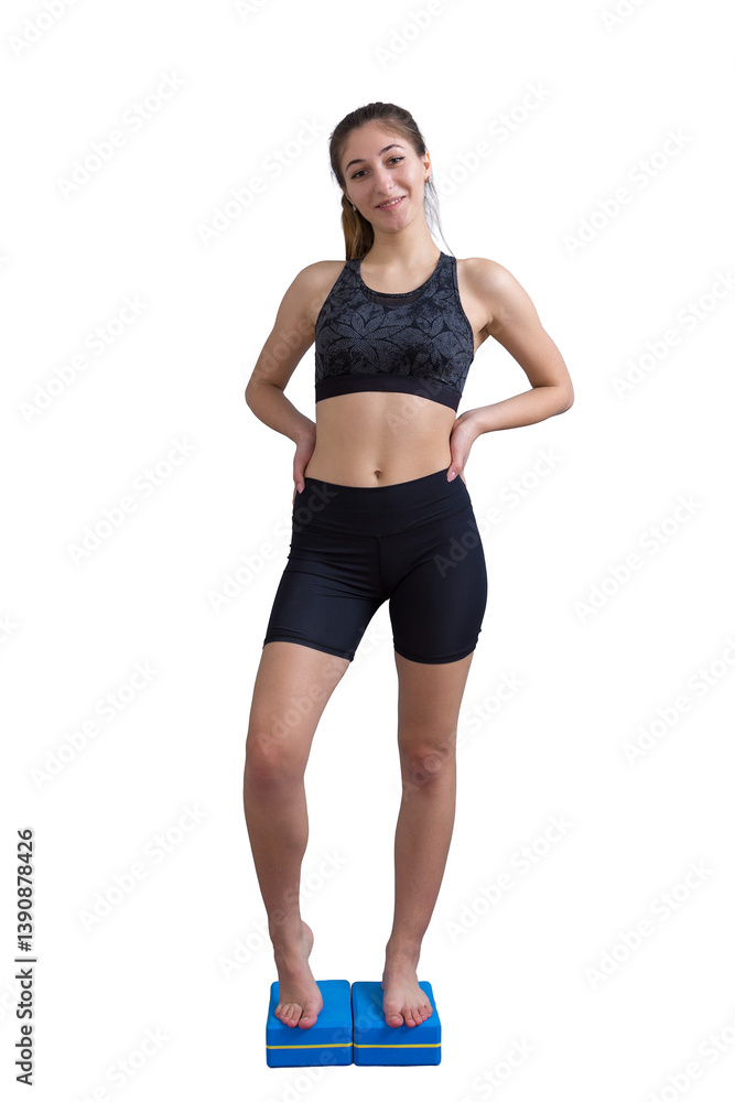 Young woman practicing yoga doing stretching exercises at home during quarantine. Minimalistic empty interior, concrete wall. Young woman practicing yoga doing stretching exercises at home during quarantine. Minimalistic empty interior, concrete wall.