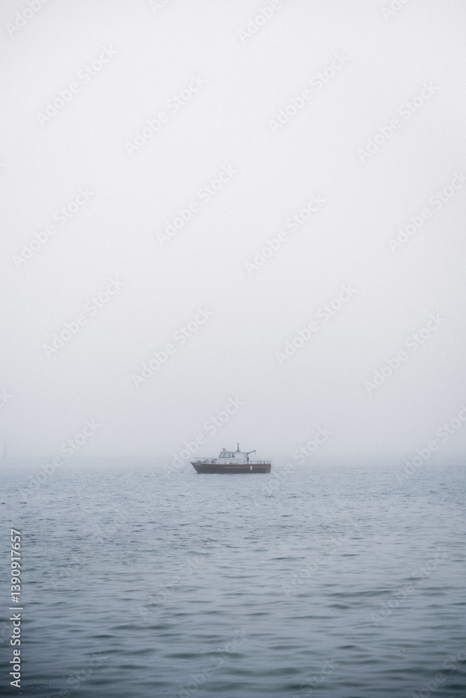Boats in the misty sea on a calm morning. Boats in the misty sea on a calm morning.