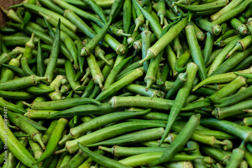 Green okra for sale at a market. Vegetable rich in fiber. Green okra for sale at a market. Vegetable rich in fiber.