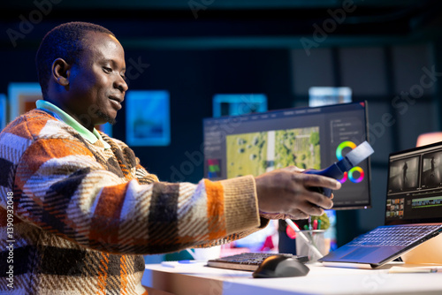 African american editing specialist enhancing gradient on film montage, working from home with color correction toolbar and gradient. Video maker edits clips footage for new movie scene.