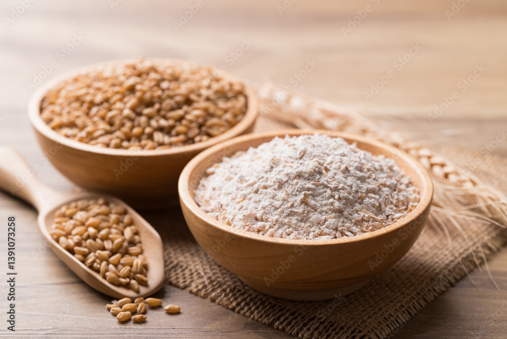 Whole wheat flour with wheat grain in bowl on wooden background Whole wheat flour with wheat grain in bowl on wooden background