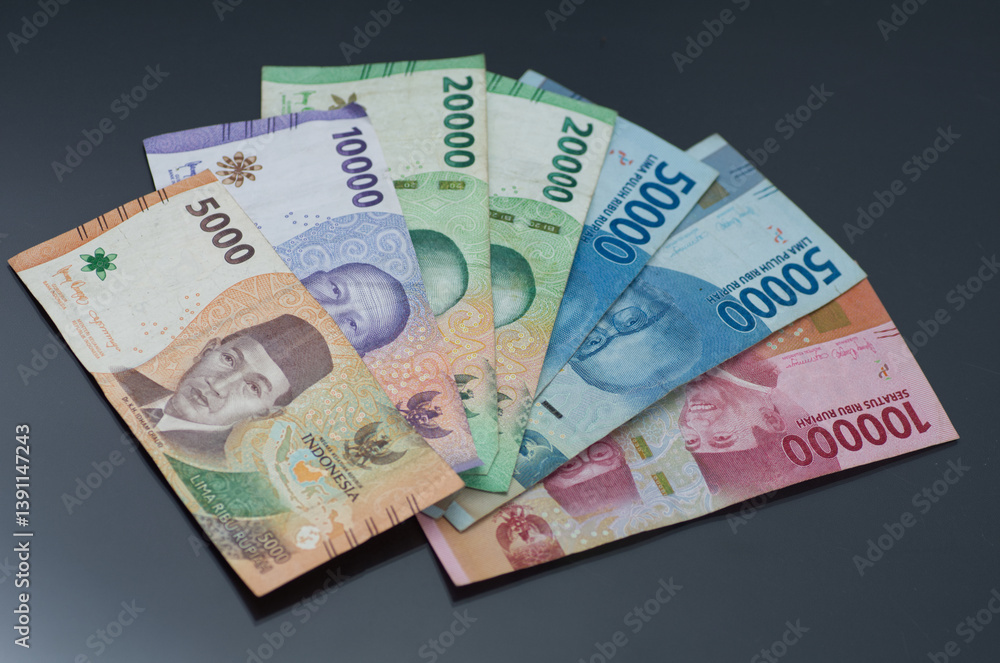Assorted Indonesian Rupiah Banknotes on a Dark Background Assorted Indonesian Rupiah Banknotes on a Dark Background