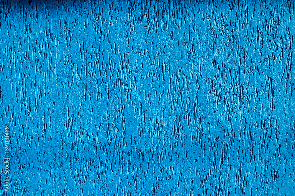 Vibrant blue wall texture with rustic finish. Close-up showing details of the coating, ideal for architecture and design concepts