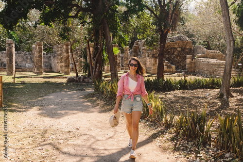 Old architecture built by Maya people of the Terminal Classic period. Young woman is spending vacation in old city.Temple of Kukulcan, UNESCO World Heritage Sites.Chicken Itza, Mexico 25 March 2025