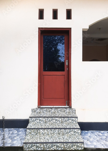 Aesthetic combination of basic architectural elements, door, vent, and stairs. Showcasing simplicity and comfort in a visually pleasing arrangement