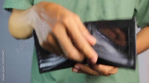 a man shows an empty wallet. a sad person because he has financial problems from a bad job and a small salary.