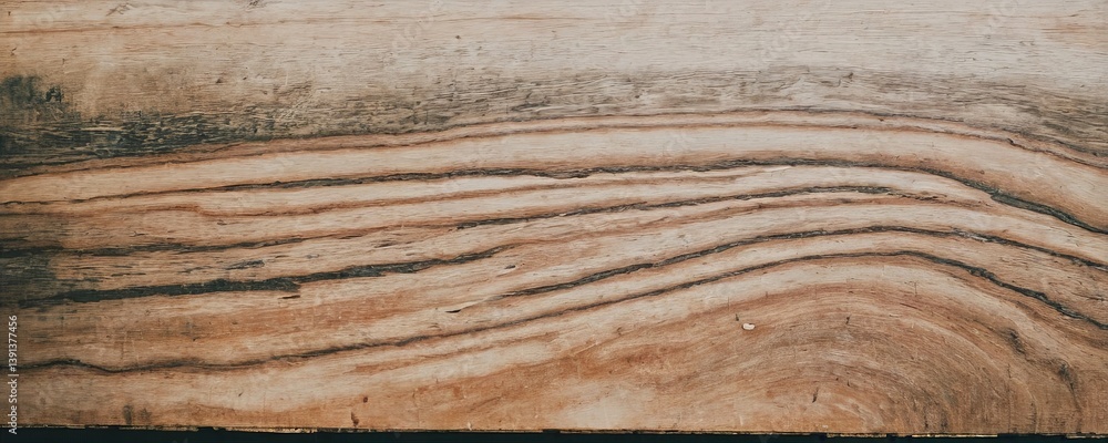 Fototapeta premium Close-up of a wooden surface showing grain patterns and natural wood texture. Rustic elegant background for interior design or wall printing.