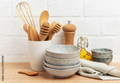 Obraz na płótnie Kitchen utensils, bowls and ingredients resting on wooden countertop by white brick wall w salonie