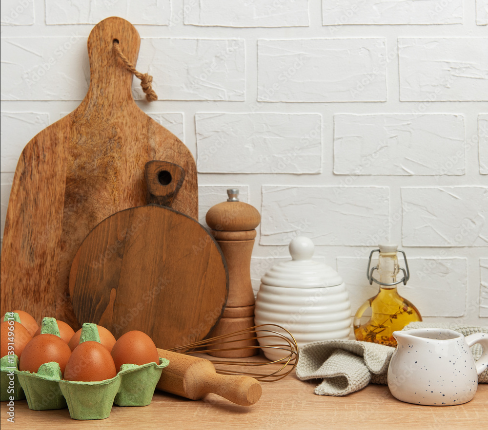 Kitchen utensils and food ingredients creating cozy culinary scene on wooden table