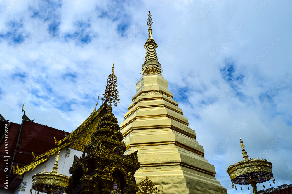 Fototapeta premium Pagoda and Chapel, Lanna architecture at Wat Phra That Cho Han, Phrae, North Thailand