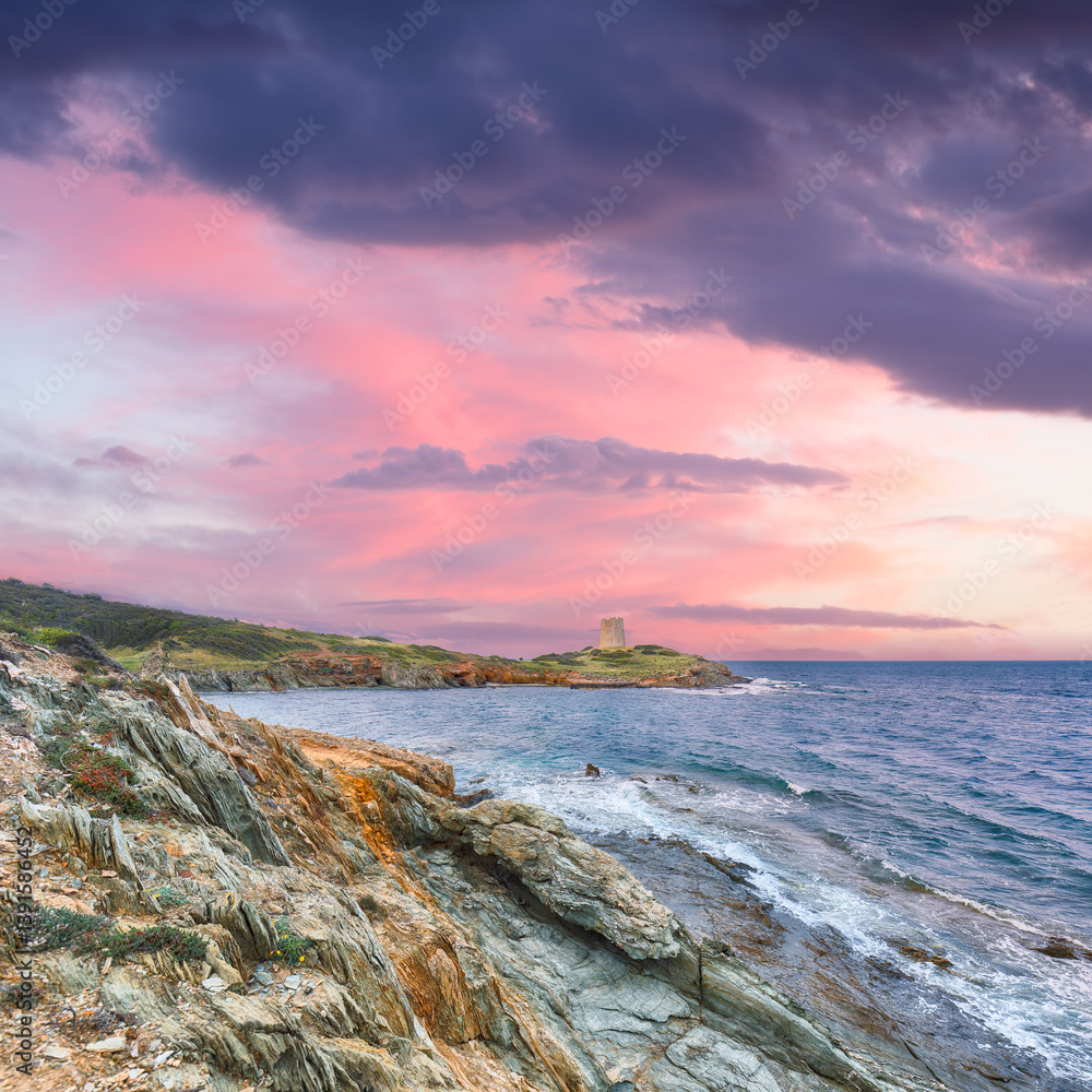Marvelous sunset view of Piscinni bay with turquoise sea and famous coastal tower of Piscinni.