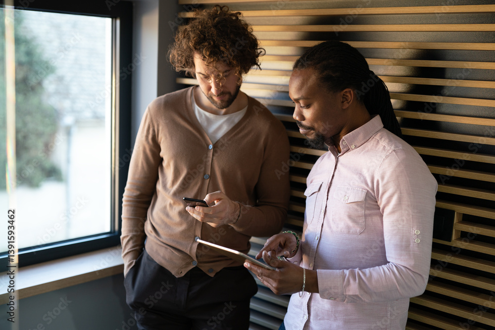 Group of young multi-ethnic startup business team collaborating on project in modern office