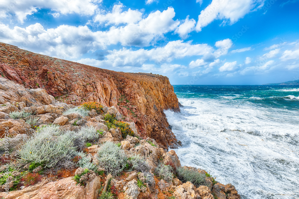 Attractive view of cliffs in valley Cala Domestica and storm on the sea