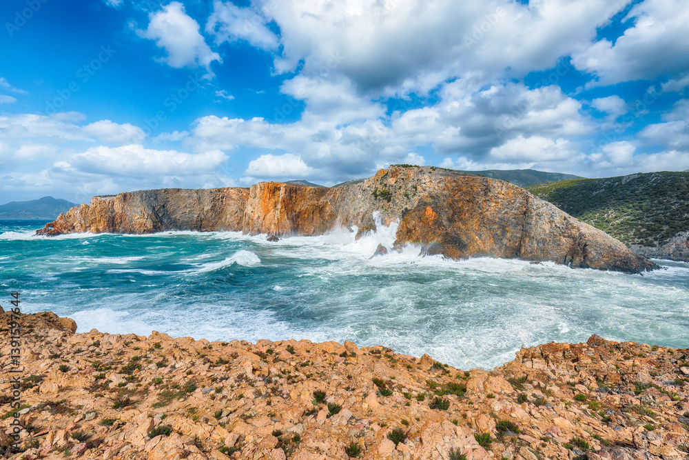 Attractive view of cliffs in valley Cala Domestica and storm on the sea