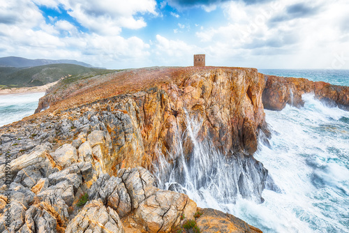 Obraz na płótnie Unbelivable view of cliffs in valley Cala Domestica with old tower and storm on the sea. w salonie