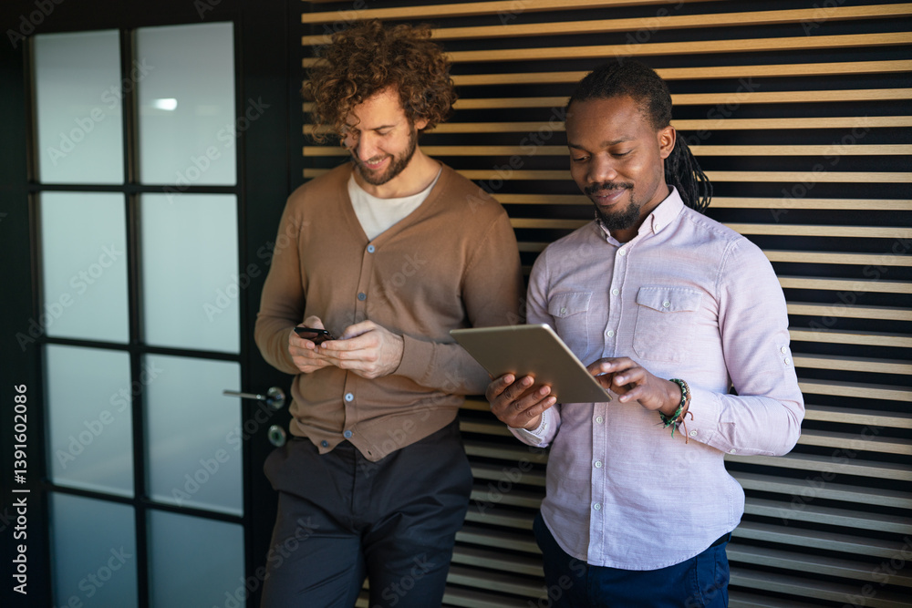 Group of young multi-ethnic startup business team collaborating on project in modern office