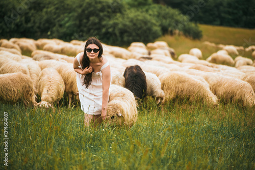 Obraz na płótnie Lady in sunglasses walking through rural sheep field w salonie