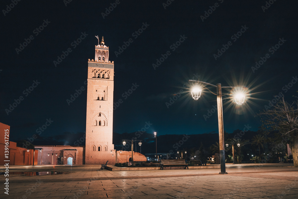 The Koutoubia Mosque and its minaret standing tall in Marrakech's Djemaa el Fna square, illuminated at night