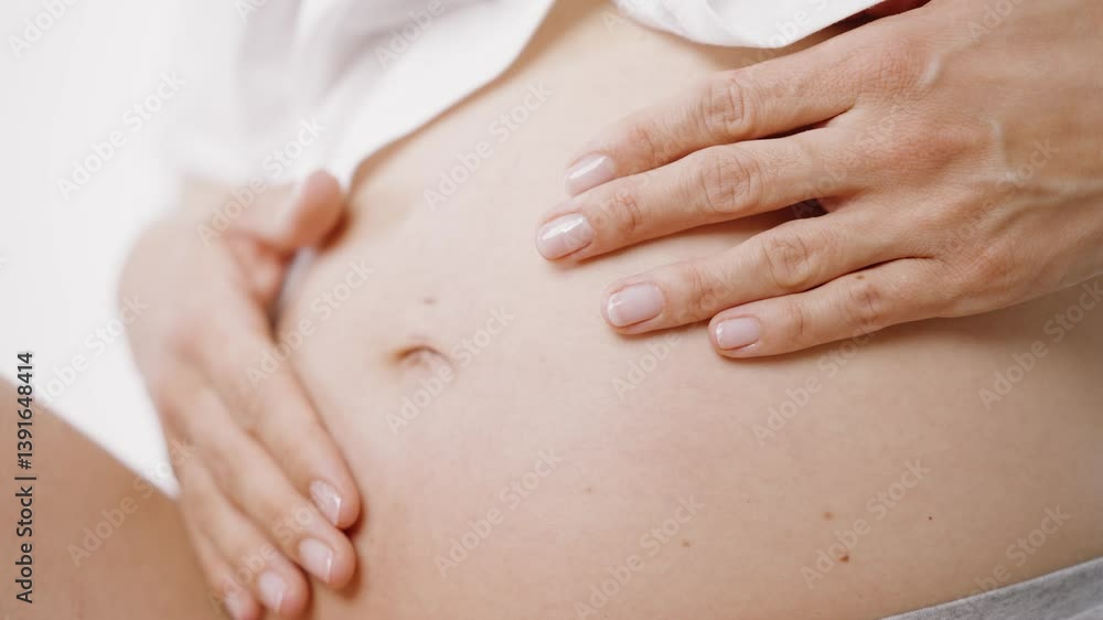 Pregnant woman gently applying cream to her belly, nurturing her skin and promoting hydration to help prevent stretch marks Pregnant woman gently applying cream to her belly, nurturing her skin and promoting hydration to help prevent stretch marks