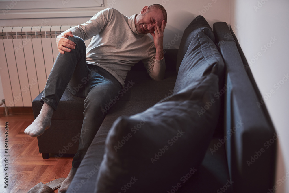 Man with painful knee and leg injury at home.