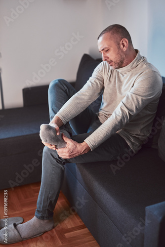 Obraz na płótnie Man with ankle and foot pain at home. w salonie