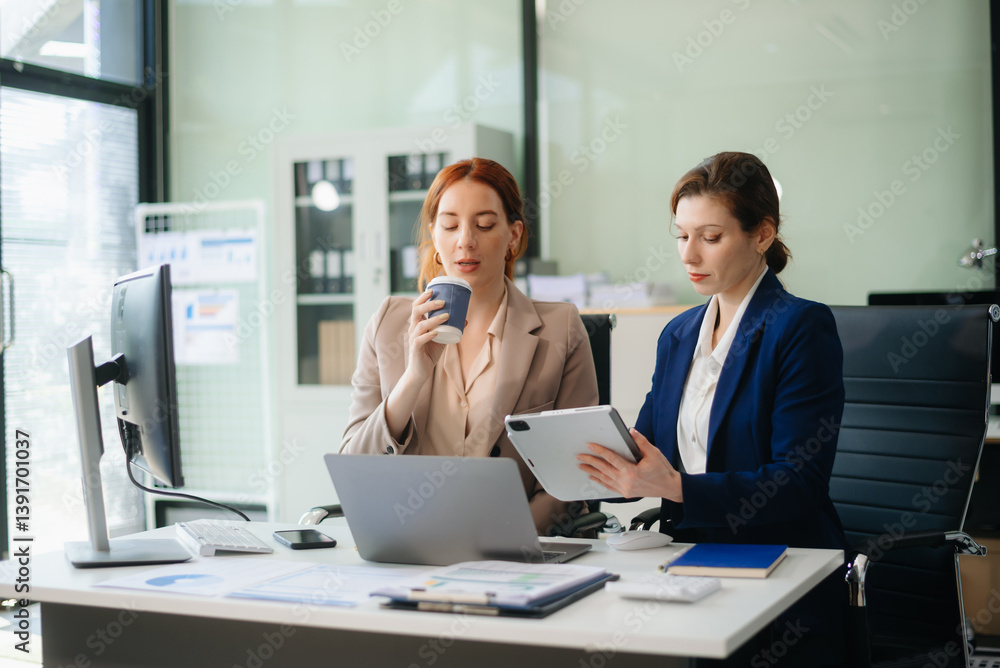 Businesswoman leading team meeting and using tablet and laptop computer with financial Businesswoman leading team meeting and using tablet and laptop computer with financial