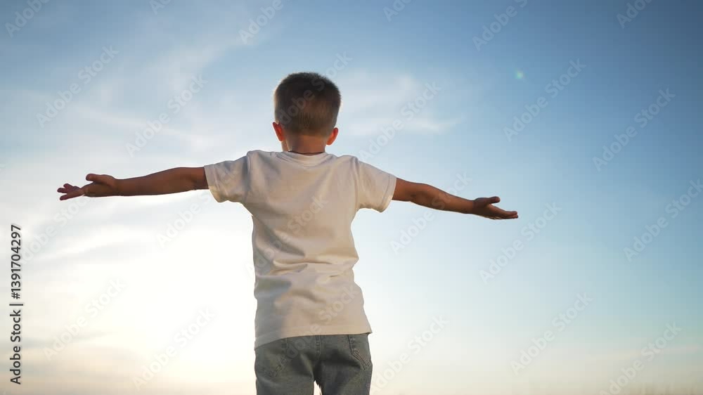 Child with arms wide open enjoying freedom. child basking nature beauty. Back view child embracing freedom under clear sky. Kid expressing joy freedom outdoors. Child celebrates happy moment in nature Child with arms wide open enjoying freedom. child basking nature beauty. Back view child embracing freedom under clear sky. Kid expressing joy freedom outdoors. Child celebrates happy moment in nature