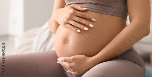 Pregnant woman in sportswea...