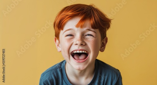 redhead kid boy on yellow plain bright background happy laughing hysterical looking at camera portrait banner with copy space ad concept marketing