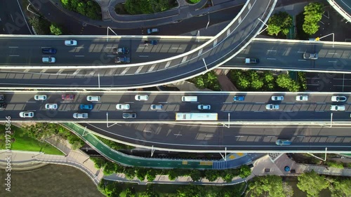 Top-down aerial footage of busy highways, interchanges, and overpasses showcasing vital urban transport arteries. Intense car movement highlights city connectivity.