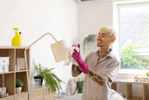 Young tattooed man cleaning...