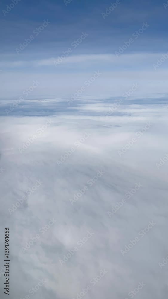 vertical View of the blue Sky above the clouds from the airplane window vertical View of the blue Sky above the clouds from the airplane window