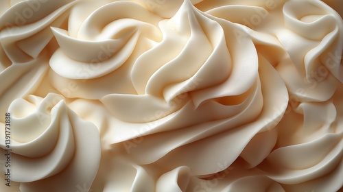A close-up view of creamy, textured swirls resembling soft whipped cream, emphasizing a smooth, delicate aesthetic.