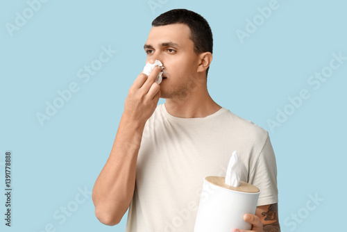 Ill young man with tissues ...