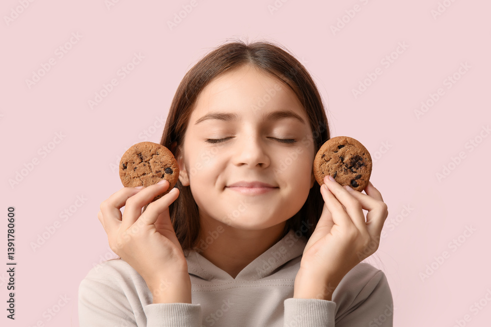 Little girl holding sweet chocolate cookies on pink background Little girl holding sweet chocolate cookies on pink background