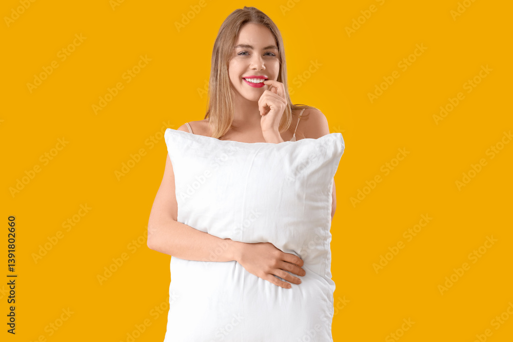Portrait of pretty young woman in pajamas with pillow on yellow background Portrait of pretty young woman in pajamas with pillow on yellow background