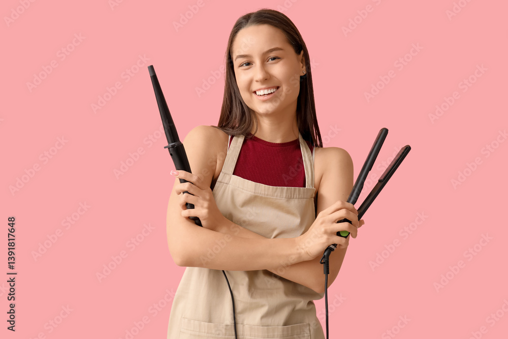 Female hairdresser with curling iron and flattening iron on pink background