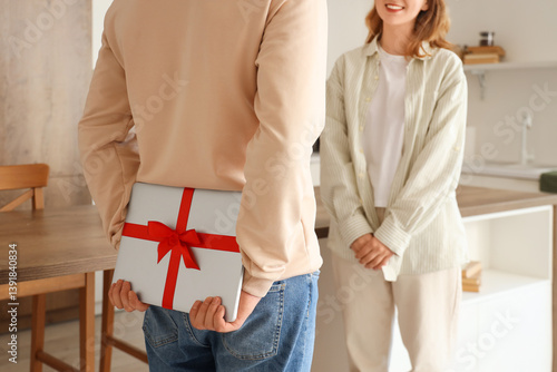 Young man with gift laptop ...