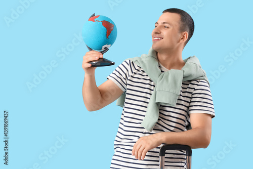Male tourist with globe and...