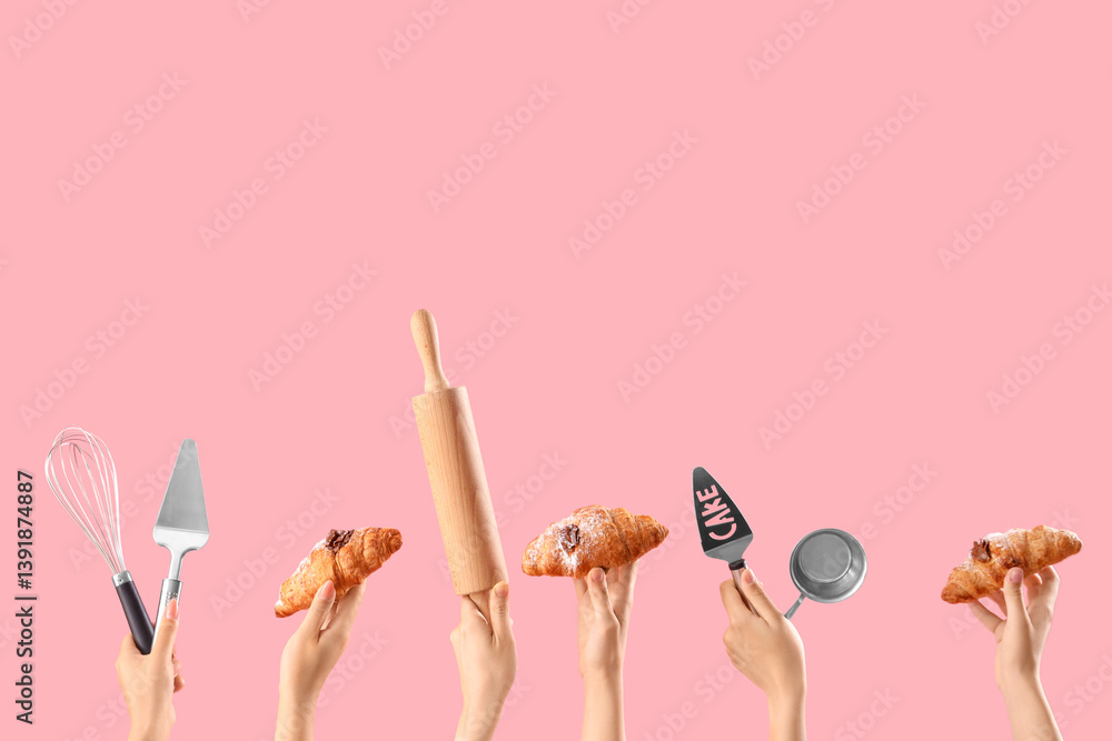 Female hands with different baking utensils and tasty croissants on pink background