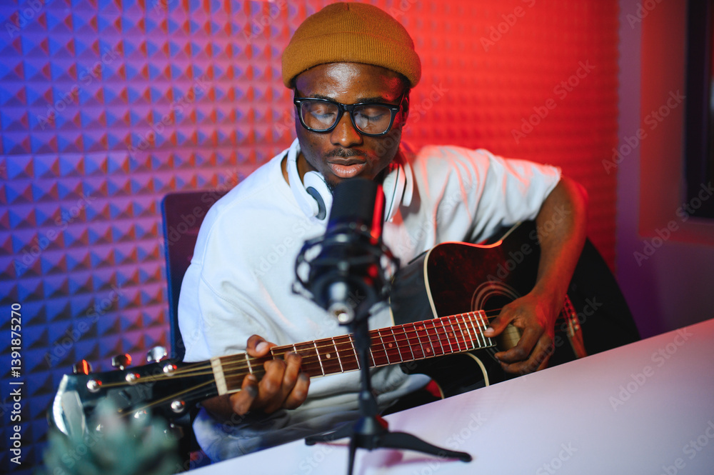 Obraz premium african american man with guitar in recording studio