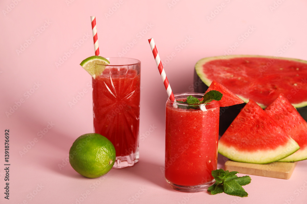 Glasses of fresh watermelon juice with lime and mint on pink background